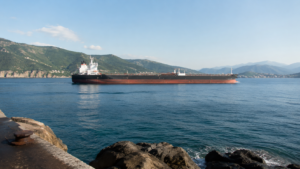 Nave cargo attraversa uno stretto marittimo in una giornata serena